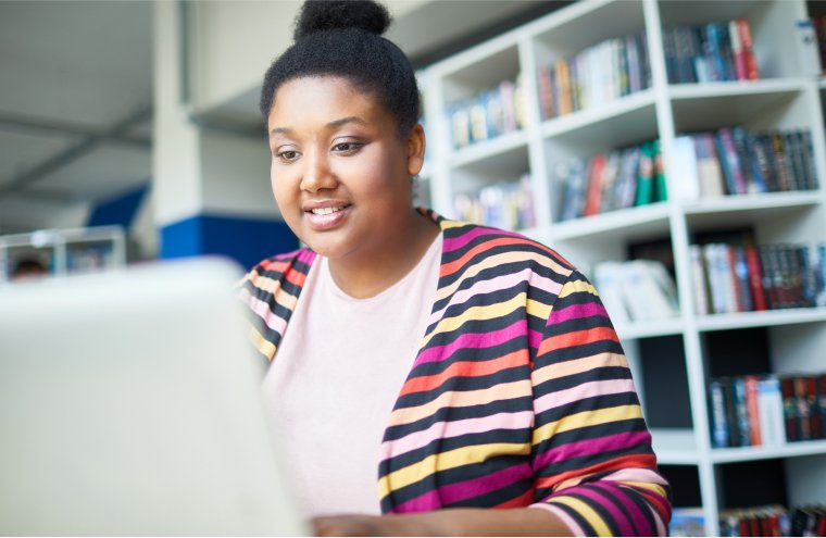 cheerful-african-student-reading-online-article-2021-09-24-02-54-27-utc 2